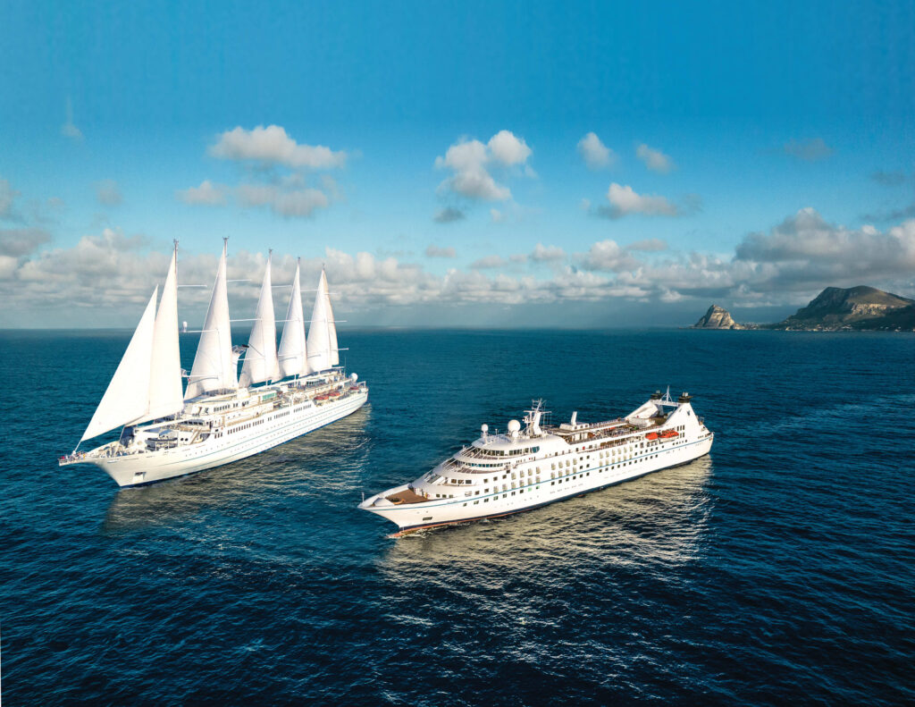 windstar cruise ship with sails on open ocean